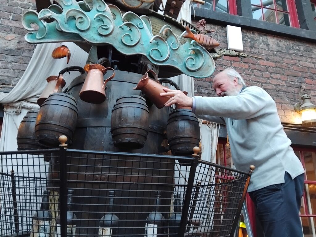 Kinetic clock restoration Jan 2026 Photo of a man working to restore a jug feature on a large kinetic clock